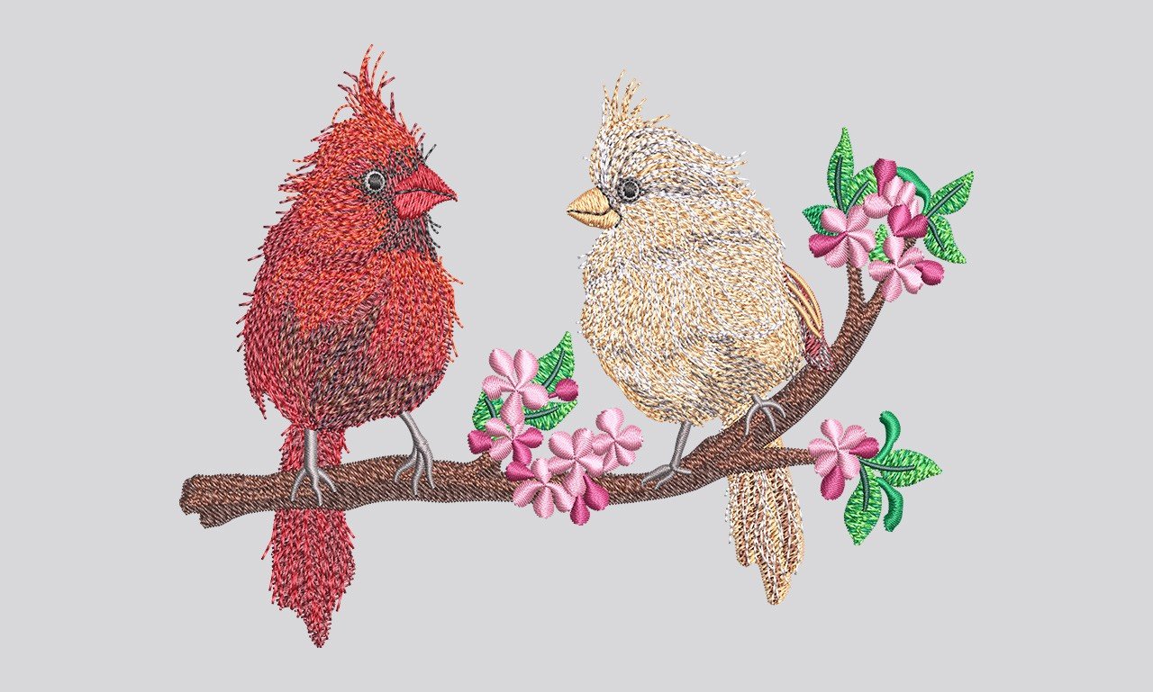 Cardinals on a blossom branch — realistic hand-digitized embroidery by ArtfulStitches